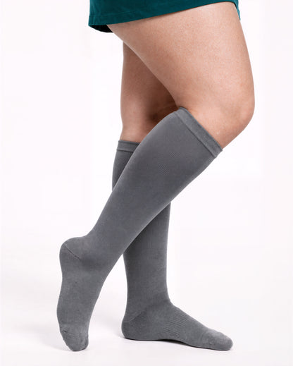 Wide Calf compression sock in Essential Gray, full knee-high coverage, standing pose