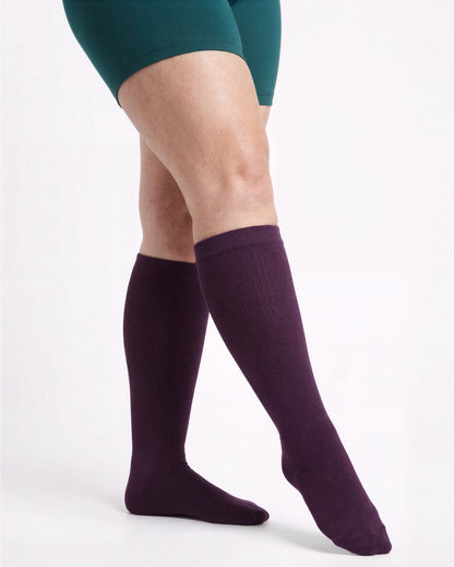 Wide Calf compression sock in Deep Purple, full knee-high coverage, standing pose