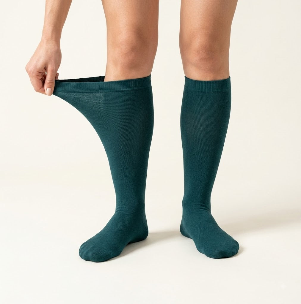 A Flowra compression sock being pulled on easily, with plenty of give at the calf