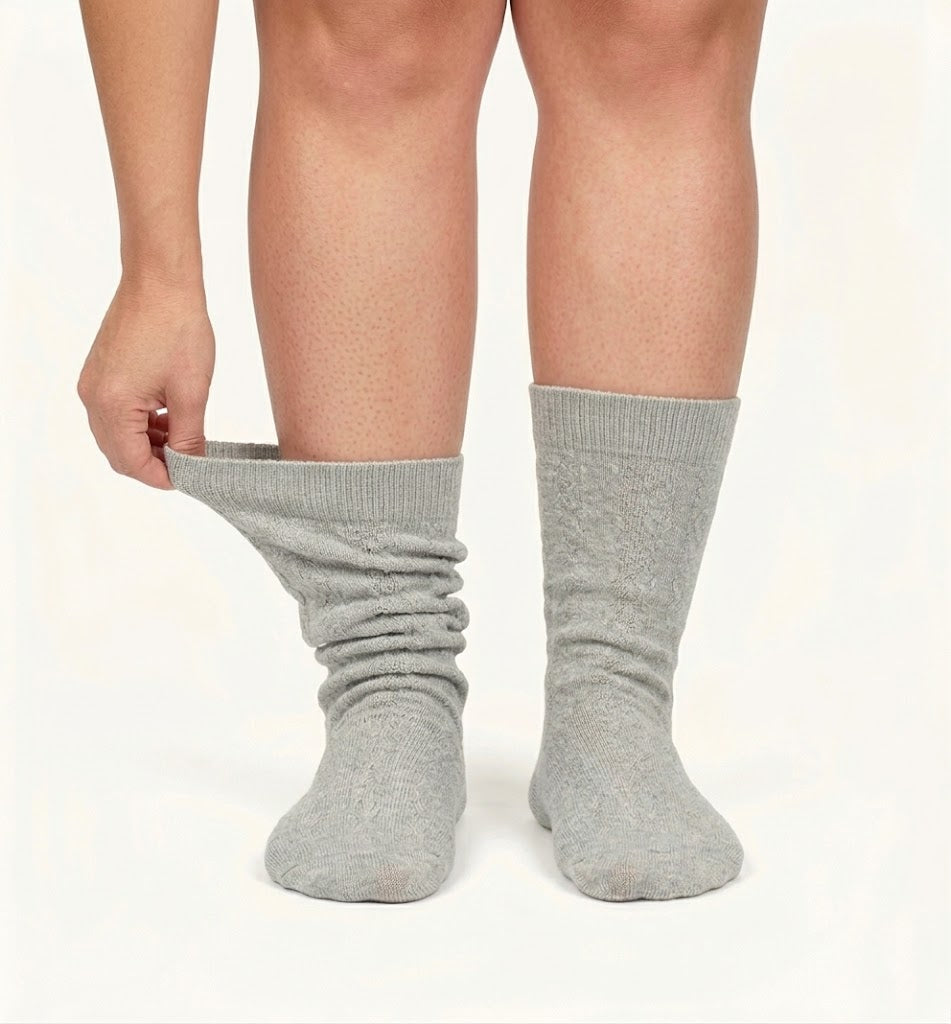 An ordinary pair of socks sagging and slipping down the leg